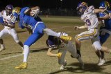 Lemoore's Aaron Villerreal trips up a Bakersfield Christian player in Friday night's Division 3 playoff game.